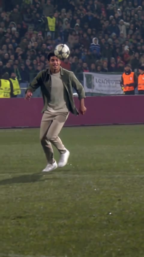 The player following the descending ball after getting past the goalkeeper in our generated clip